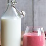 kefir milk for dogs in bottle with strawberry kefir smoothie in glass alongside.