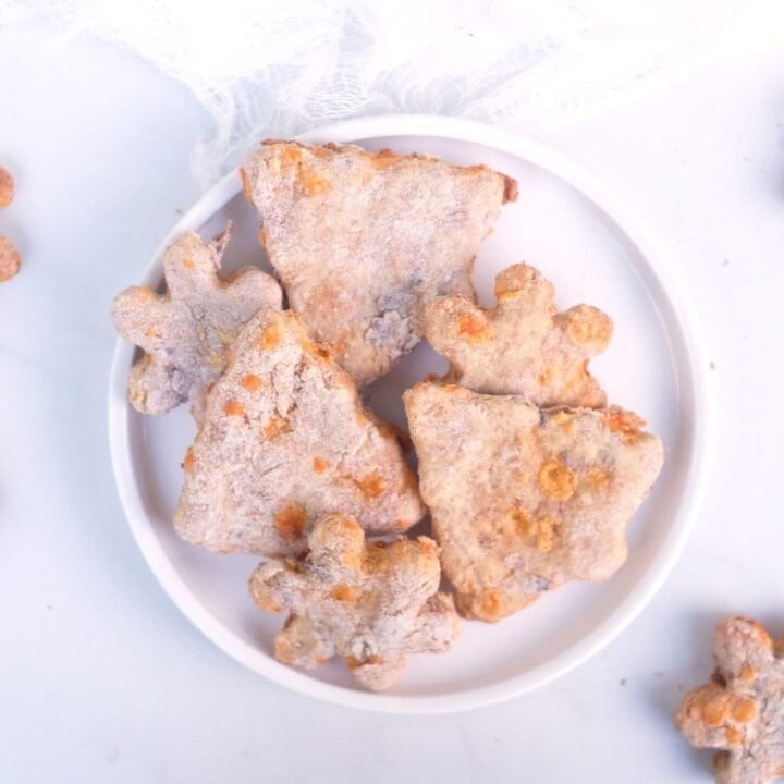 cheese and bacon homemade christmas dog treats in white bowl.